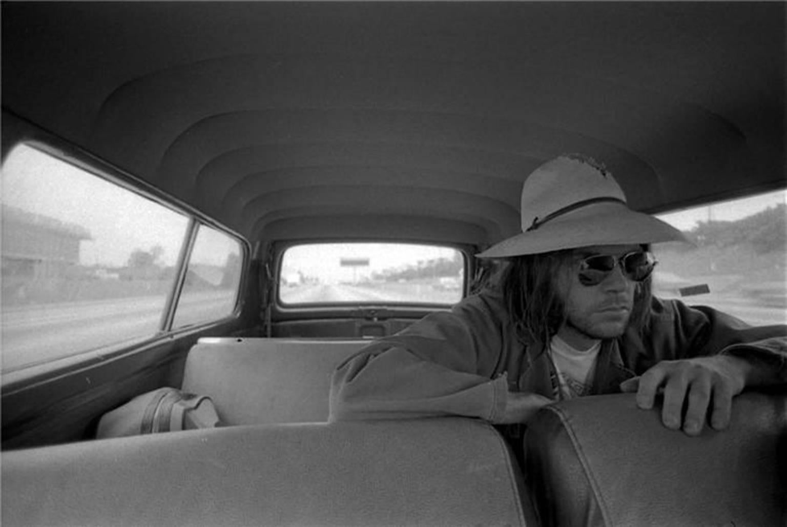 Henry Diltz Black and White Photograph - Neil Young in the Back Seat