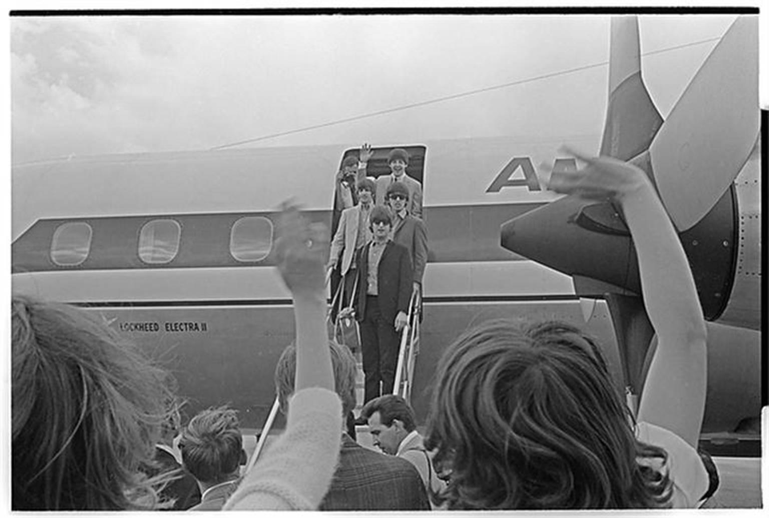 Curt Gunther Black and White Photograph - Beatles Coming off Plane