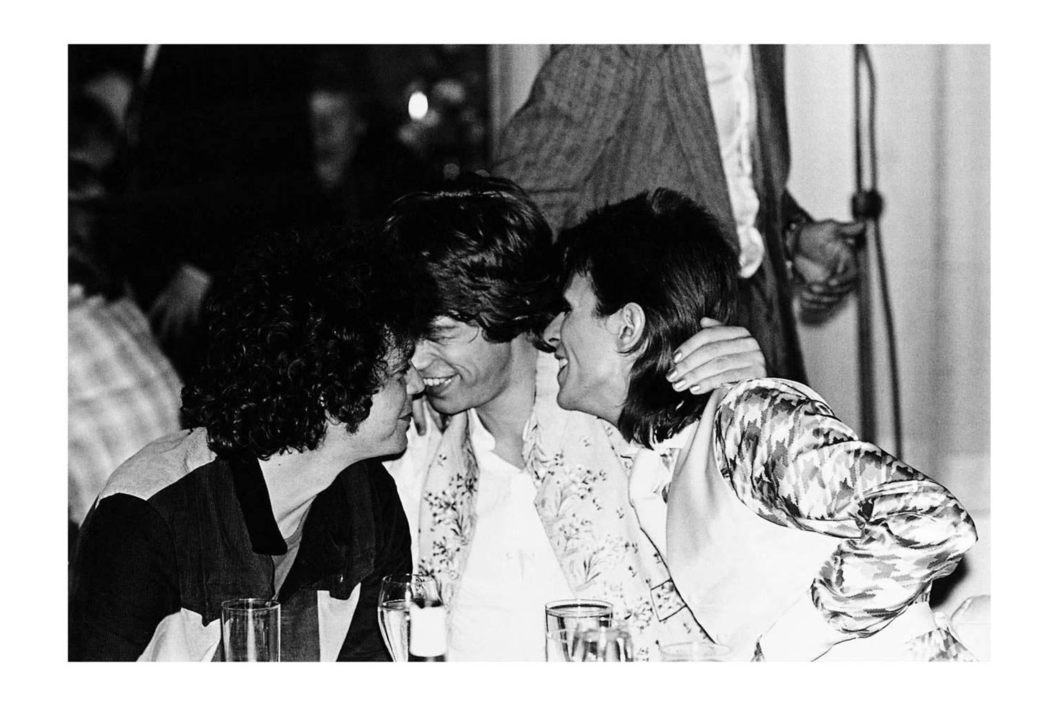 Mick Rock Black and White Photograph - Lou Reed, Mick Jagger, David Bowie, Cafe Royale, London 1973