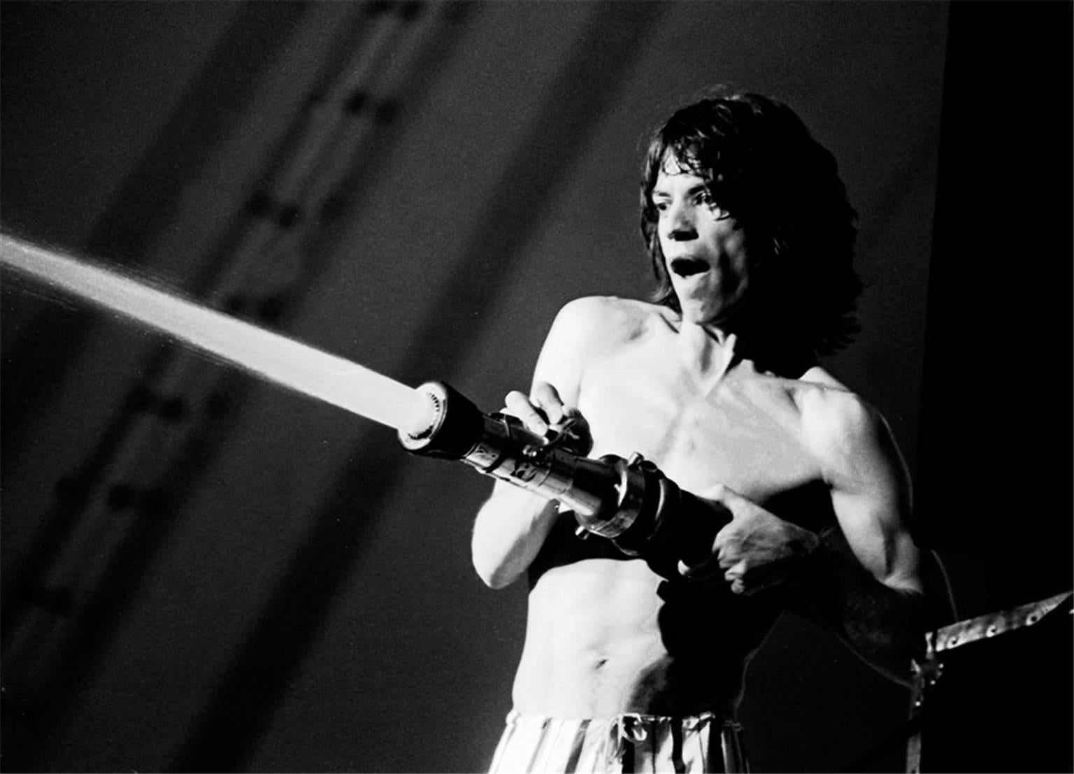 Jay Dickman Black and White Photograph - Mick Jagger sprays audience
