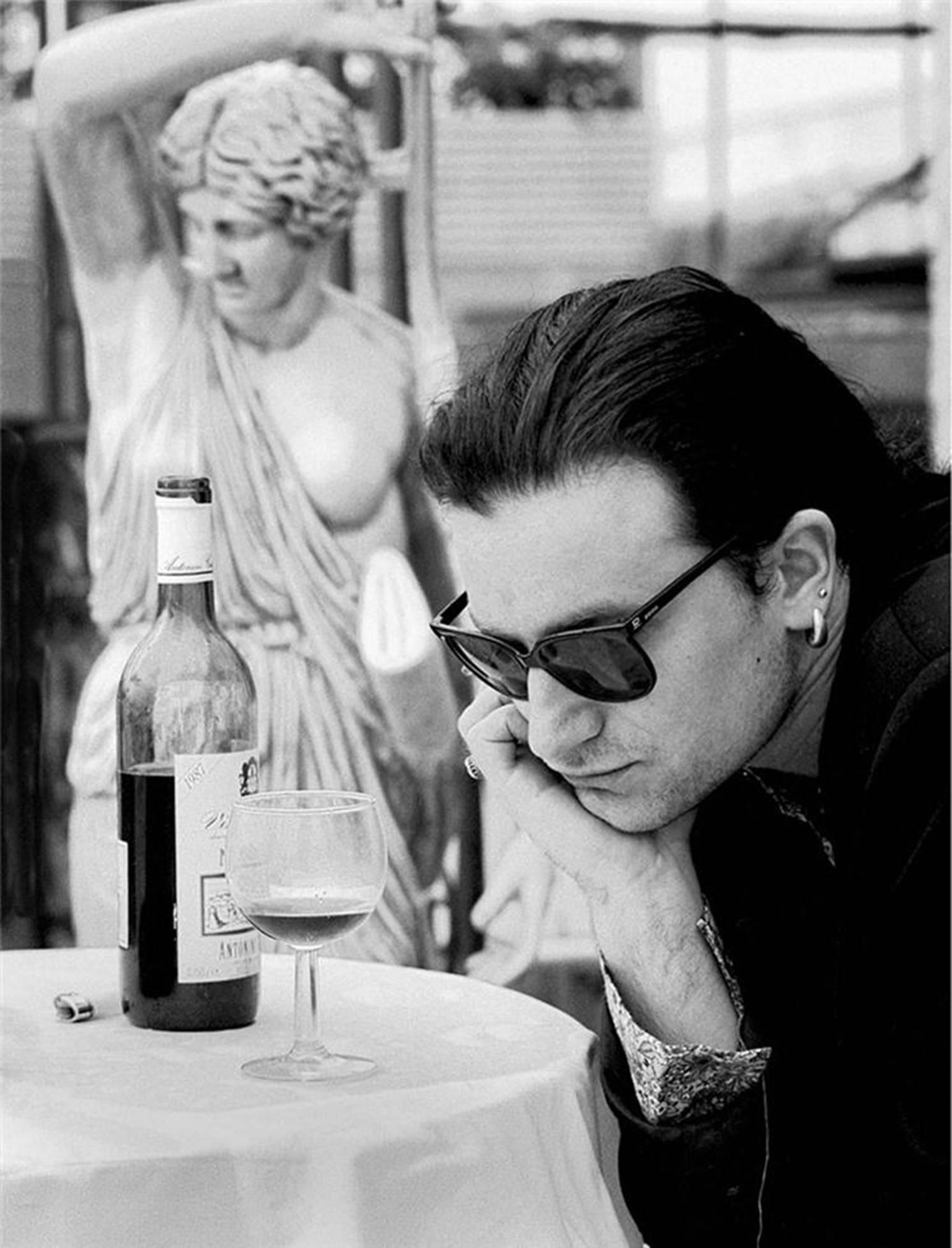 Colm Henry Black and White Photograph - Bono with wine glass in Rome, 1989