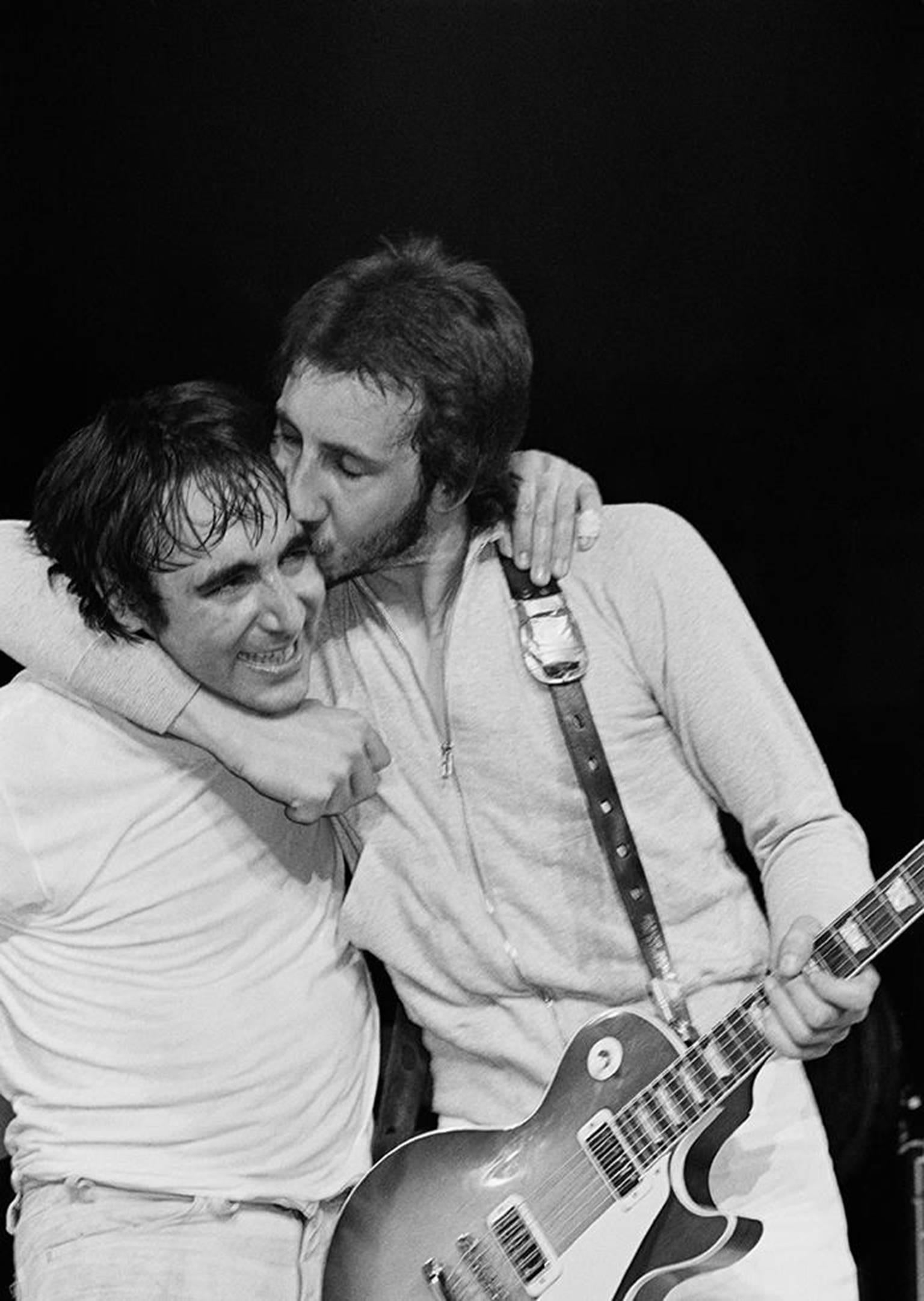Bill Green Black and White Photograph - Pete Townshend Kissing Keith Moon, 1974