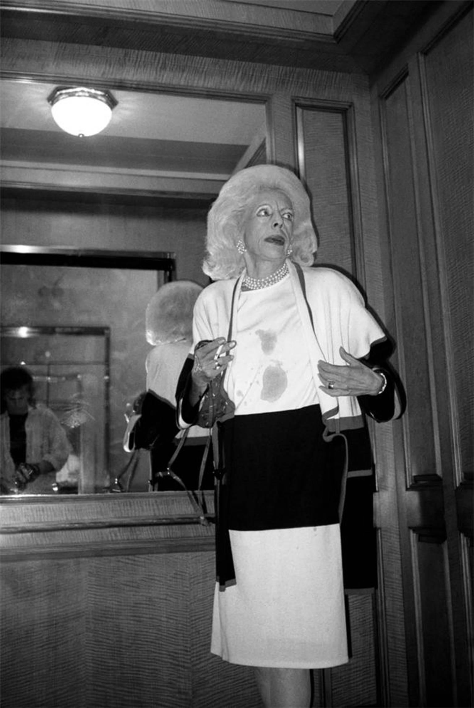 Graham Nash Black and White Photograph - Woman in elevator, Philadelphia, PA 1995