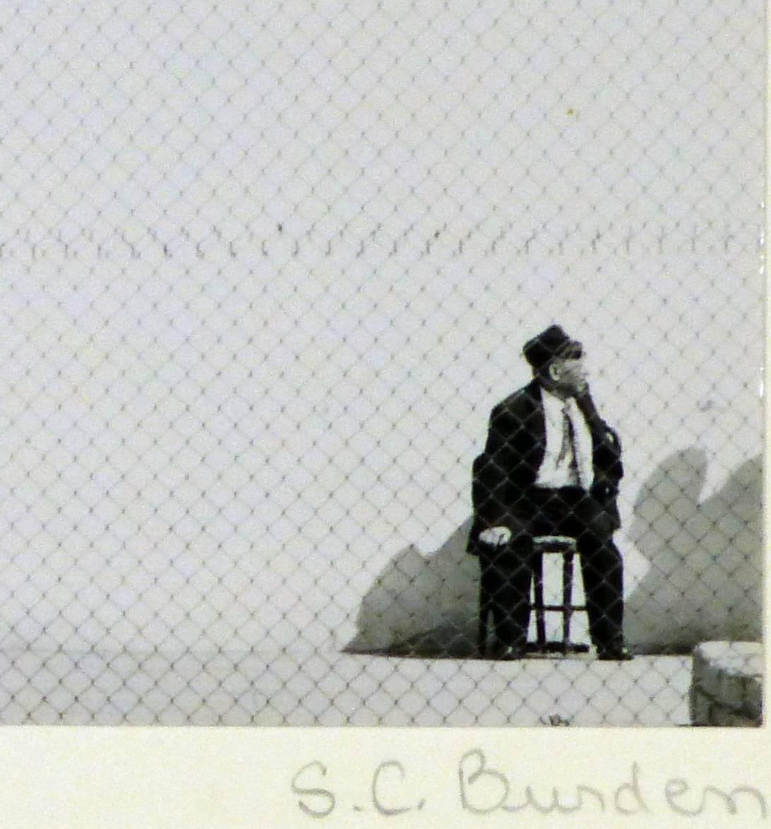 Original pencil signed silver-gelatin photograph of a man sat at a basketball court by photographer Shirley Carter Burden, 1953. Signed "S.C. Burden" lower right. 

From a personal folio of pictures dedicated to his niece Shim of the