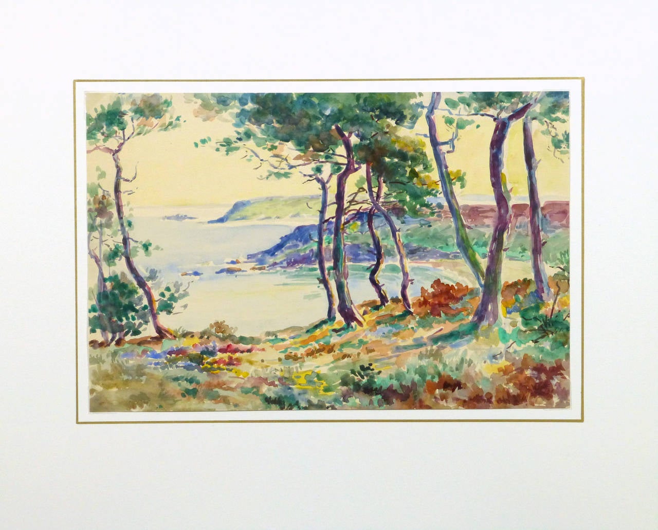 Scenic watercolor landscape of the vantage point of the sea from a secluded, tree dappled spot by French artist Roger Tochon, circa 1930. Unsigned. 

Original one-of-a-kind work of art on paper displayed on a white mat with a gold border. Mat fits a