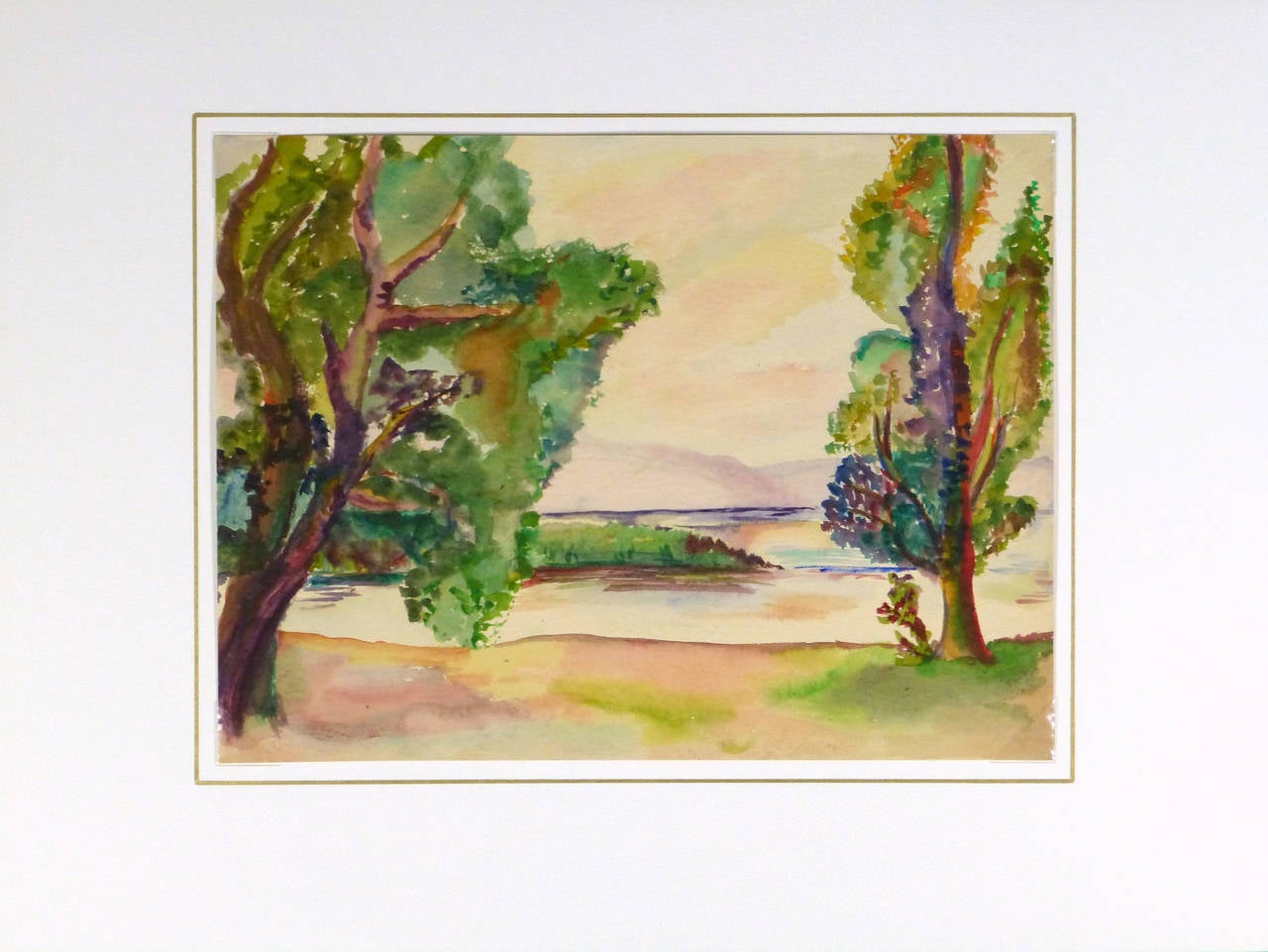 Luminous and colorful watercolor landscape painting of lush green trees framing a smooth and placid lake by artist Erika Schob, 1941.

Original one-of-a-kind artwork on paper displayed on a white mat with a gold border. Mat fits a standard-size