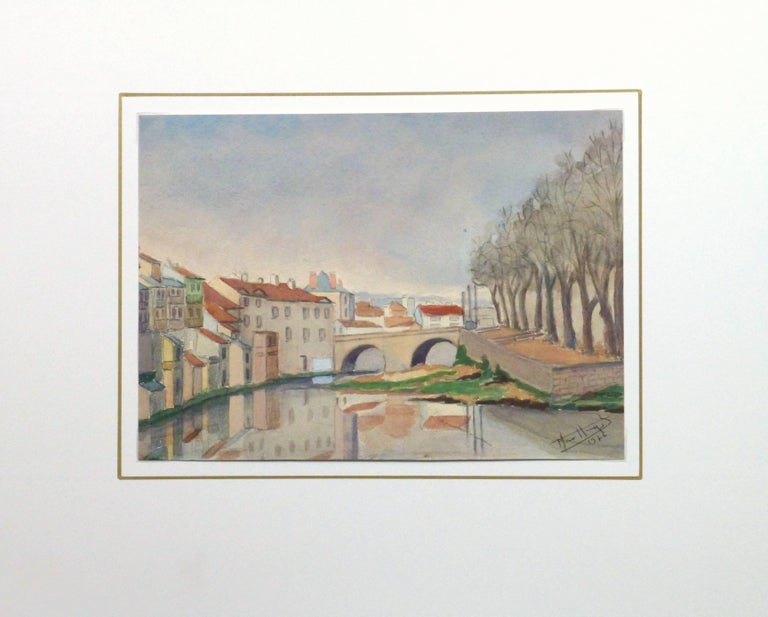 Serene watercolor landscape along the banks of the La Jordanne River looking at the Pont du Buis bridge in he picturesque city of Aurillac located  in the Auvergne-Rhône-Alpes region of south-central France, 1976. Signed and dated lower right.