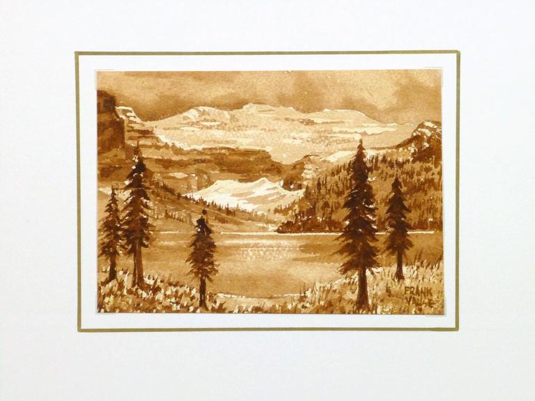 Rustically charming watercolor landscape of mountain peaks rising over a lake surrounded by pines in a bright sienna tone by Frank Valise, circa 1940. Signed lower right.

Original one-of-a-kind artwork on paper displayed on a white mat with a gold
