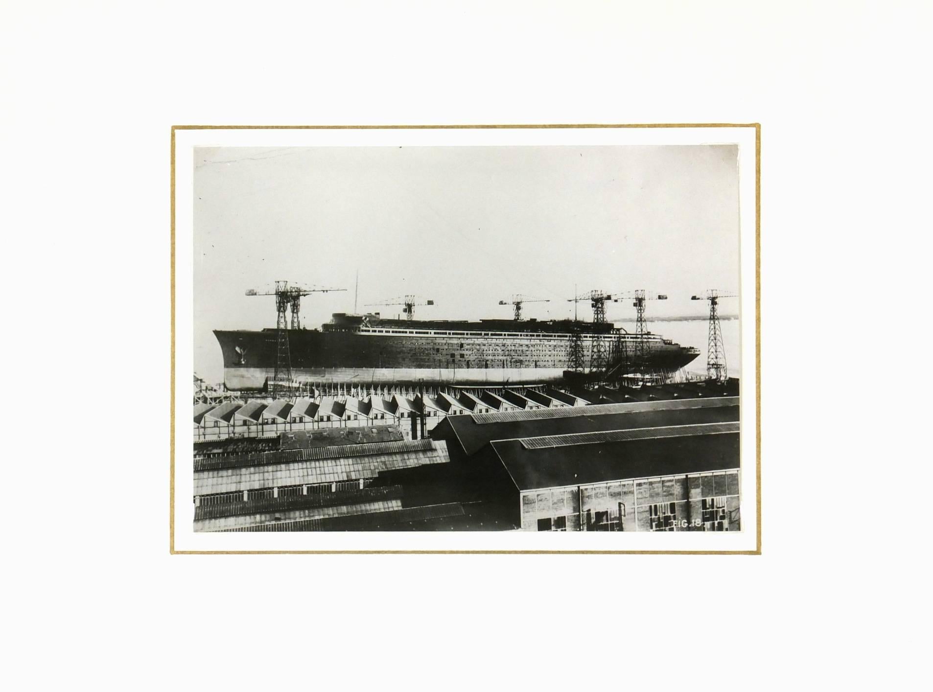 Fabulous industrial French black and white photograph of the construction of the luxury steamer "Le Normandie".

Original one-of-a-kind artwork on paper displayed on a white mat with a gold border. Mat fits a standard-size frame. Archival