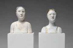 2 small portraits with gold and silver caps