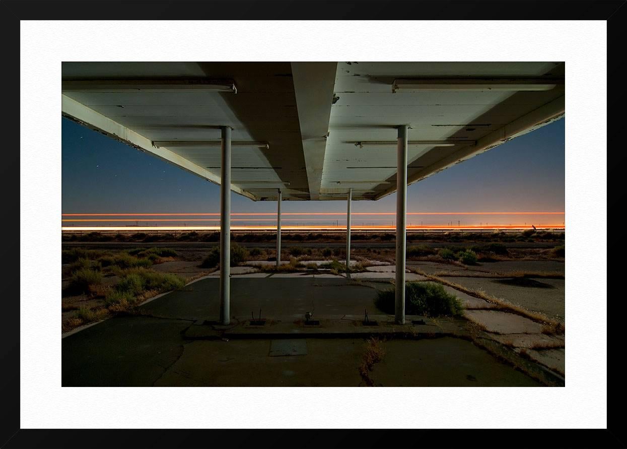 ABOUT THIS PIECE: This photograph was taken looking south from under the canopy at an abandoned gas station in the sleepy desert community of North Edwards, California. The highway passing by is California 58. Directly on the other side is the