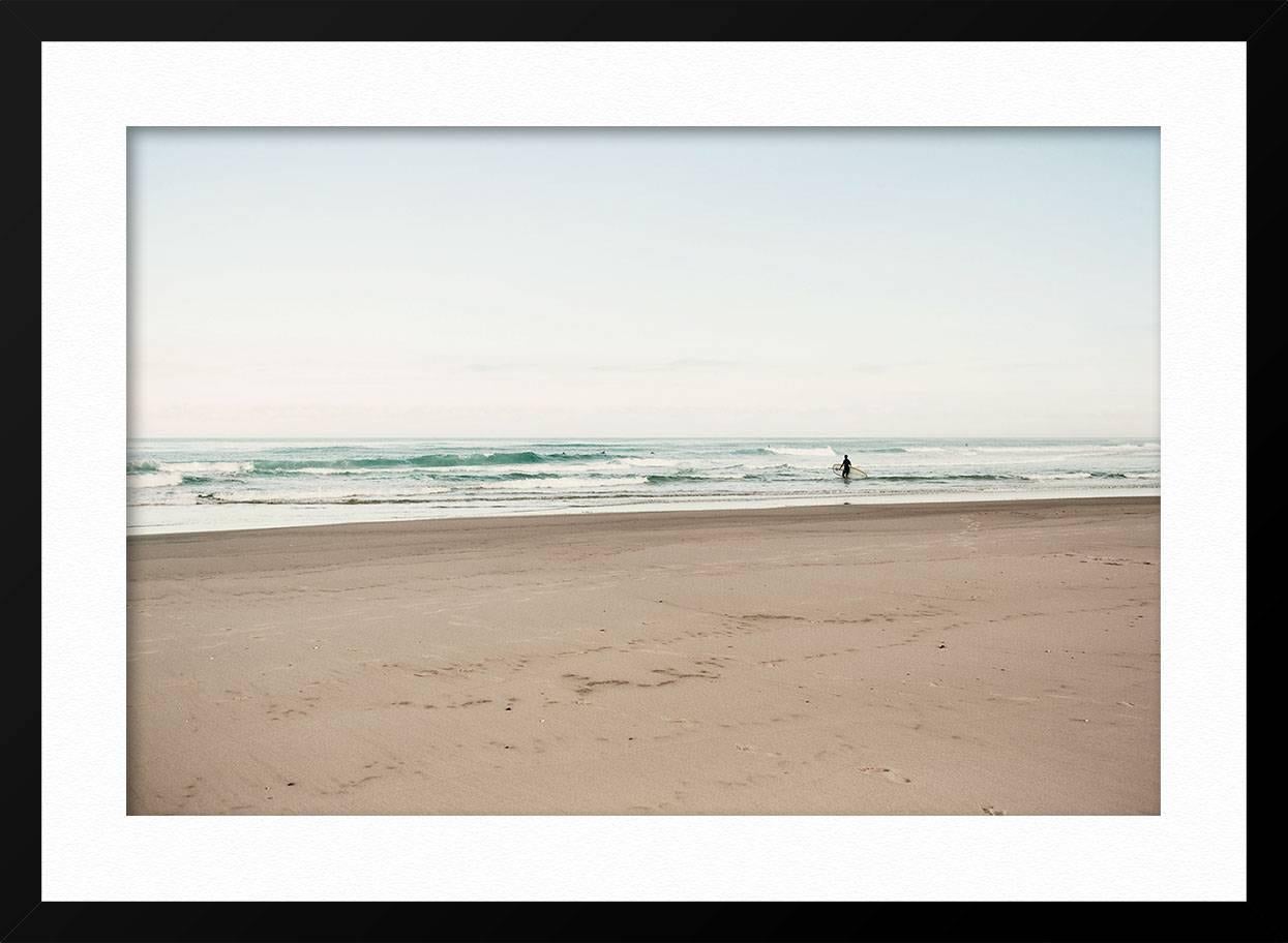 ABOUT THIS PIECE: Biscarrosse is a town in western France, located south west of Bordeaux. French photographer Ludwig Favre captures a lone surfer going out in the early morning waves. Our curators like the calmness of the image. It looks best large
