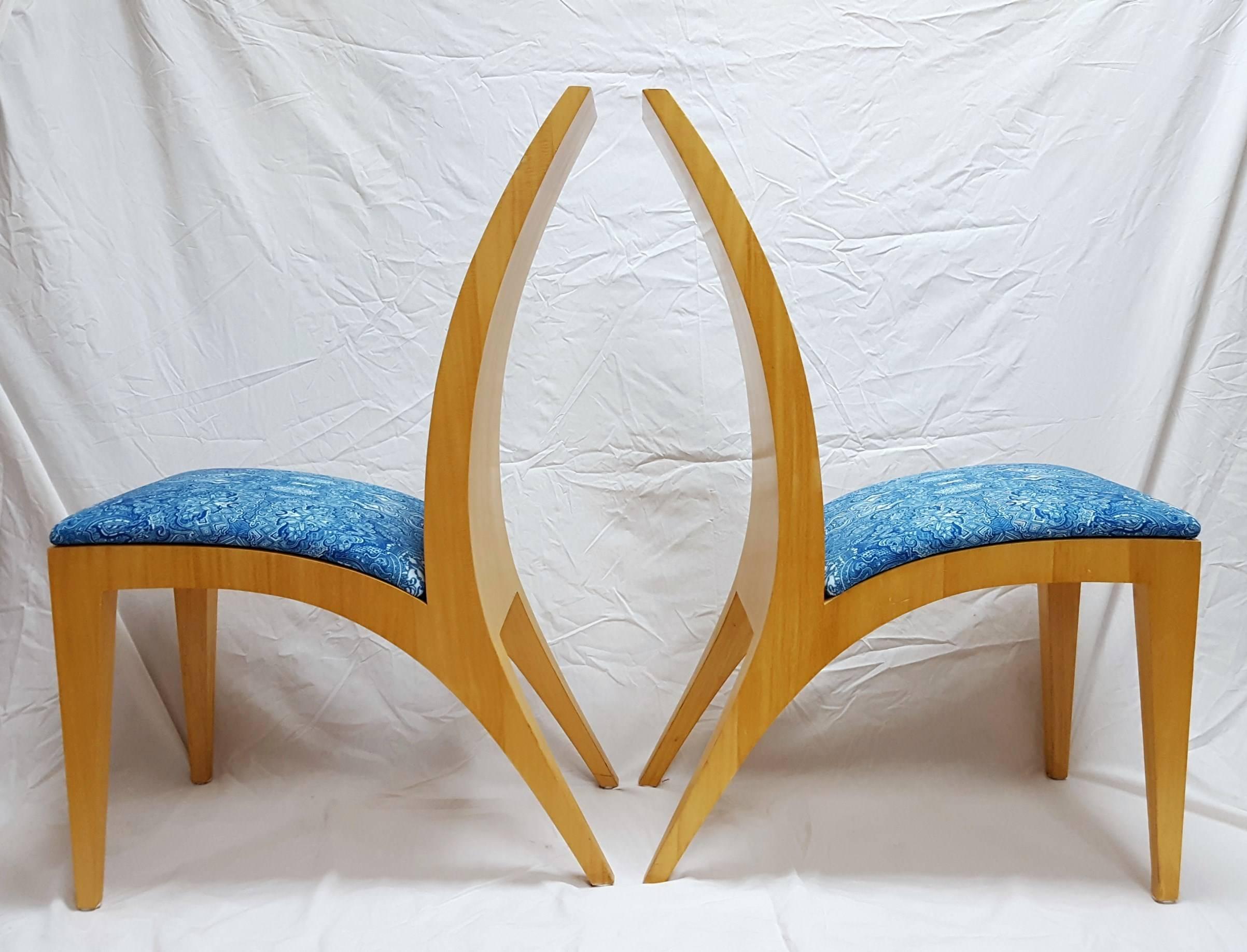 A pair of Anigre wood Italian mid-century modern chairs with removable fabric covered cushioned seats designed by American artist Jack Graves III (1988-), 2015. Chairs have sweeping back legs and flared backs. The chairs are circa 1950's, Italy. The