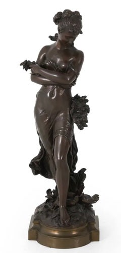 Fine Patinated bronze sculpture of a classically dressed female holding flowers