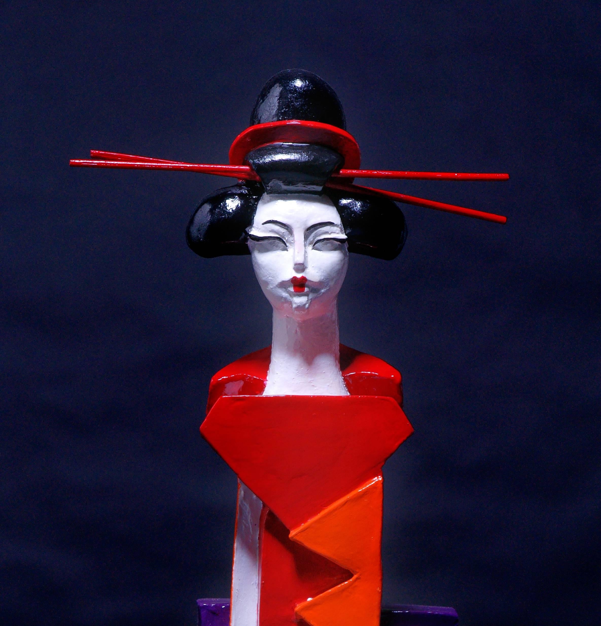 Mariko’s Eiffel is an unique contemporary sandstone sculpture painted with orange, red, purple, black and white enamel. 
The geishas collection of the artist expresses the various faces of the femininity.   

Mariko grew up in Africa, where she