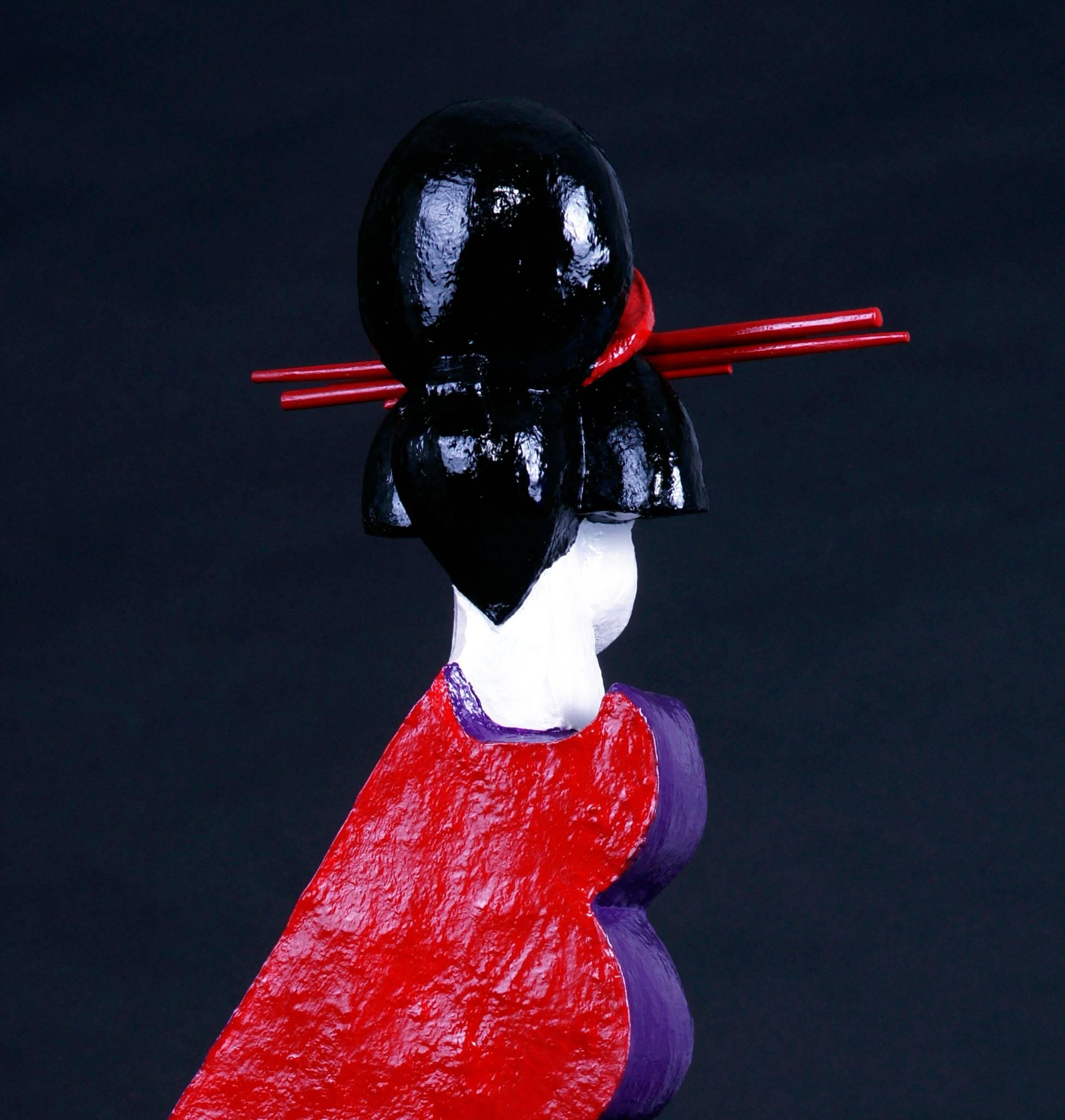 Mariko’s Gouvernante is an unique contemporary sandstone sculpture painted with red, purple, black and white enamel. The geishas collection of the artist expresses the various faces of the femininity. 
  
Mariko grew up in Africa, where she