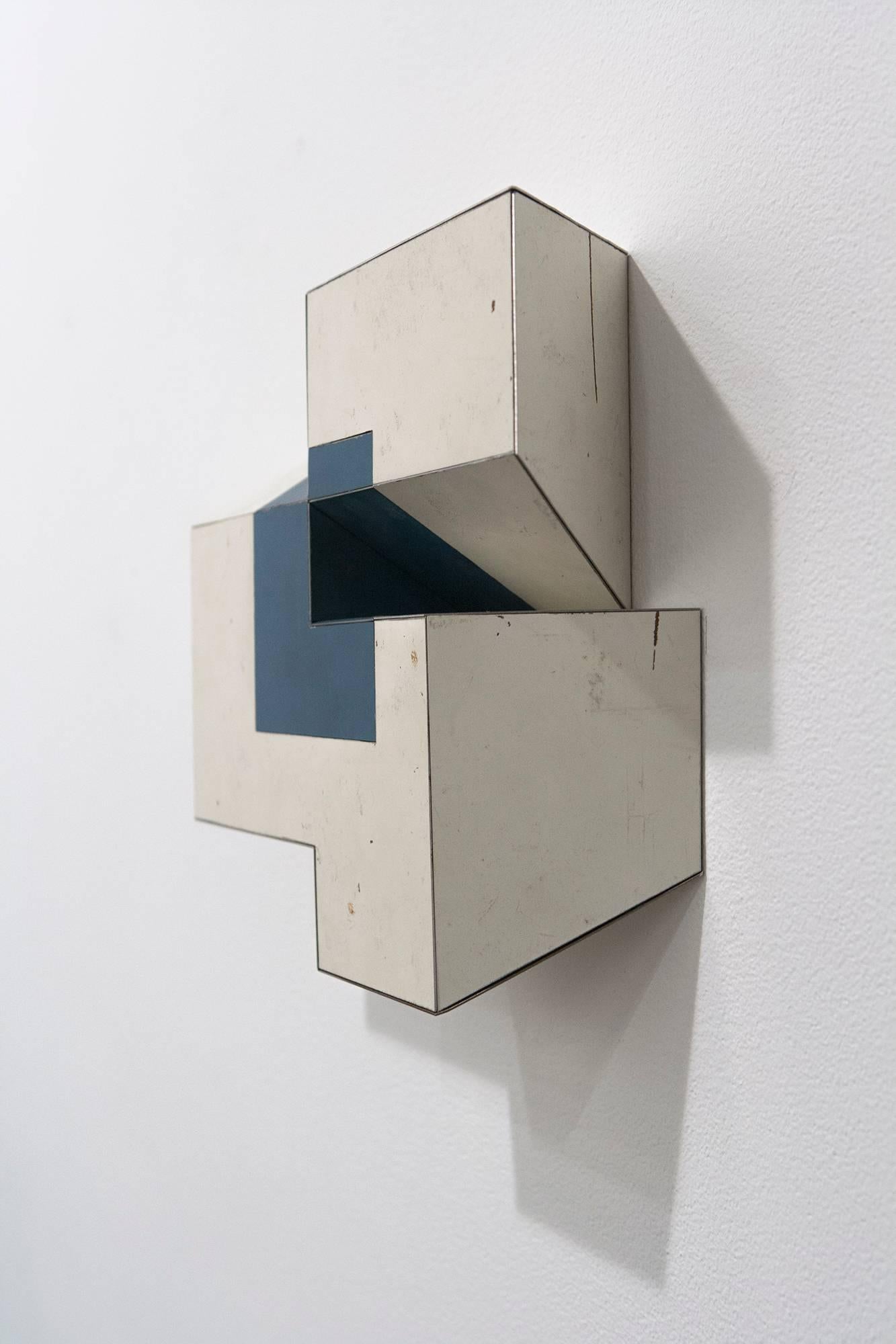 Ted Larsen's Almost Exactly is a hard-edged sculptural, mixed media painting. Primary colors include white and hues of blue. Almost Exactly is a graphic, architectural, minimalist three dimensional painting. Constructivist, Bauhaus, abstract