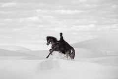 Black Horse and Cloaked Rider Crossing White Sand Dunes