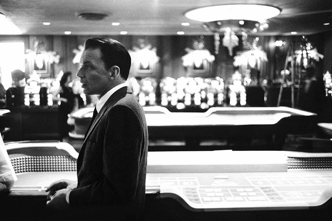 Bob Willoughby Black and White Photograph - Frank Sinatra in Front of the Craps Tables at the Sands Hotel, Las Vegas