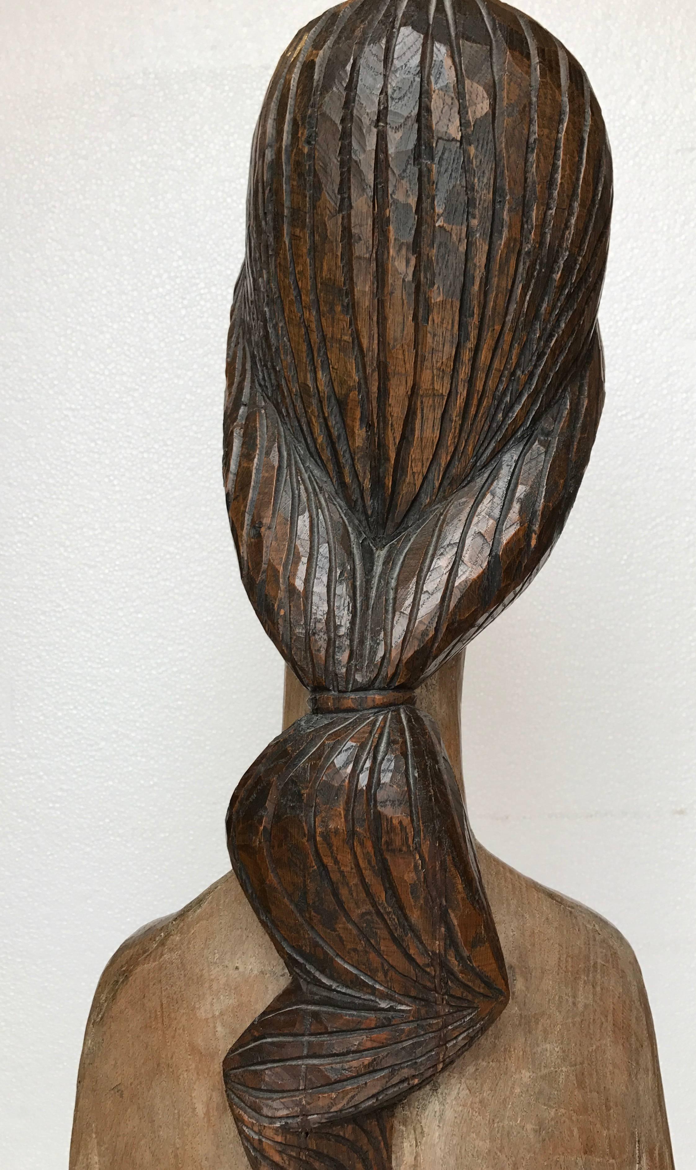 Handcarved sculpture from a solid piece of oak by the French Sculptor, Francois Brochet. Signed along the top of painted bodice verso. Dated 1964. In good condition. Old repair of narrow crack running vertical verso.  On thick oak base.  Overall