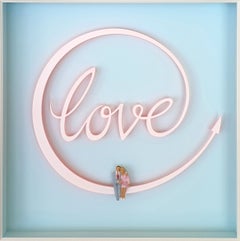 Love - contemporary art work, romantic couple sitting on love sign