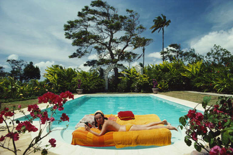 Slim Aarons Color Photograph - Sunbathing in Barbados