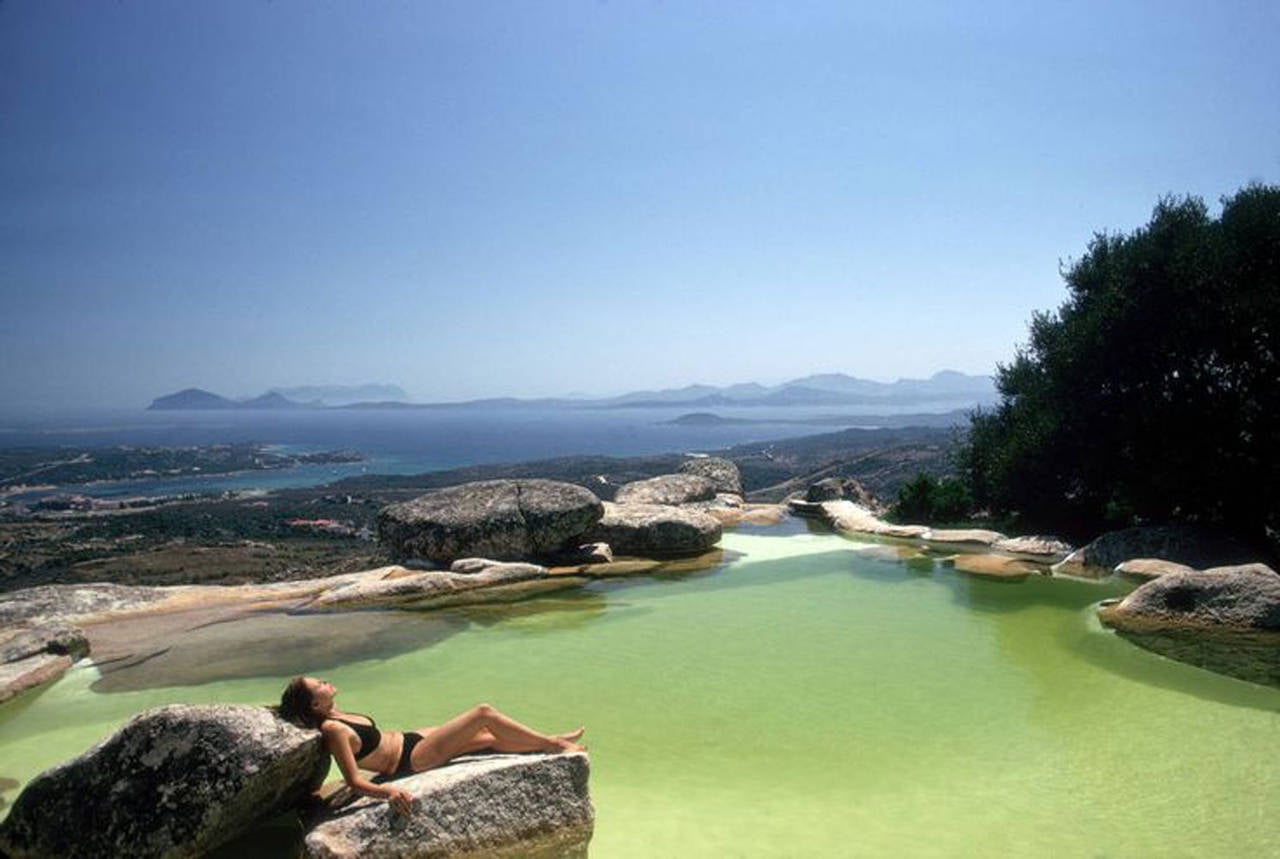 Slim Aarons 'Sunbather on Rock, Costa Smeralda Sardinia, Italy' (Estate Edition)