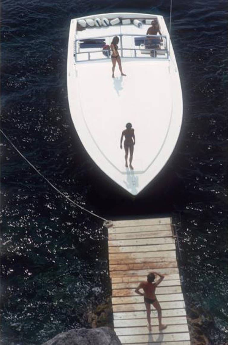 Slim Aarons Landscape Photograph - Speedboat Landing, 1973 (Porto Ercole, Italy)