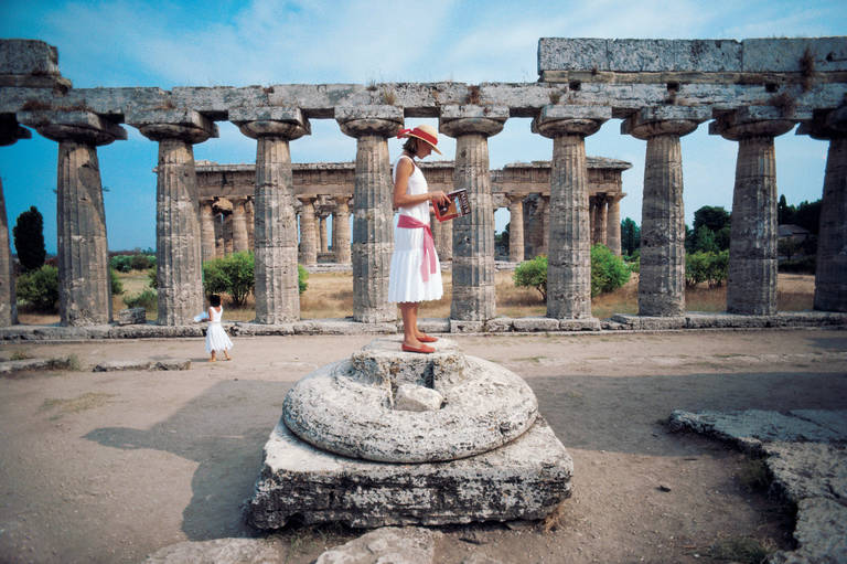 Slim Aarons Landscape Photograph - Laura Hawk amid the ancient Greek ruins of Paestum, on the Gulf of Salerno, 1984