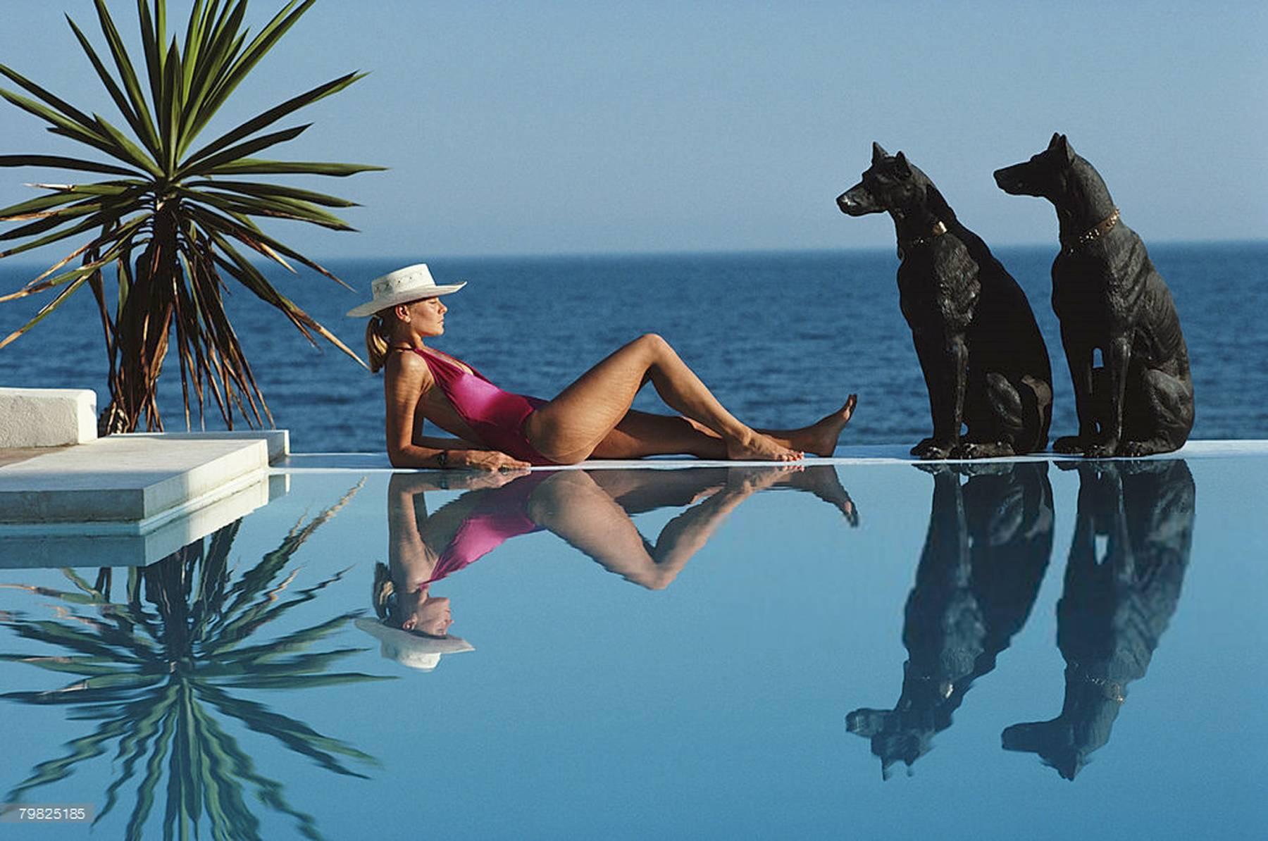 Laura Hawk, assistant to the Slim Aarons, relaxes by the pool at El Rincon, the von Pantz' Marbella home, September 1st, 1985.

Marbella Pool
Slim Aarons Estate Edition
40 x 60 inches

Aarons was known for catching moments that appear effortless,