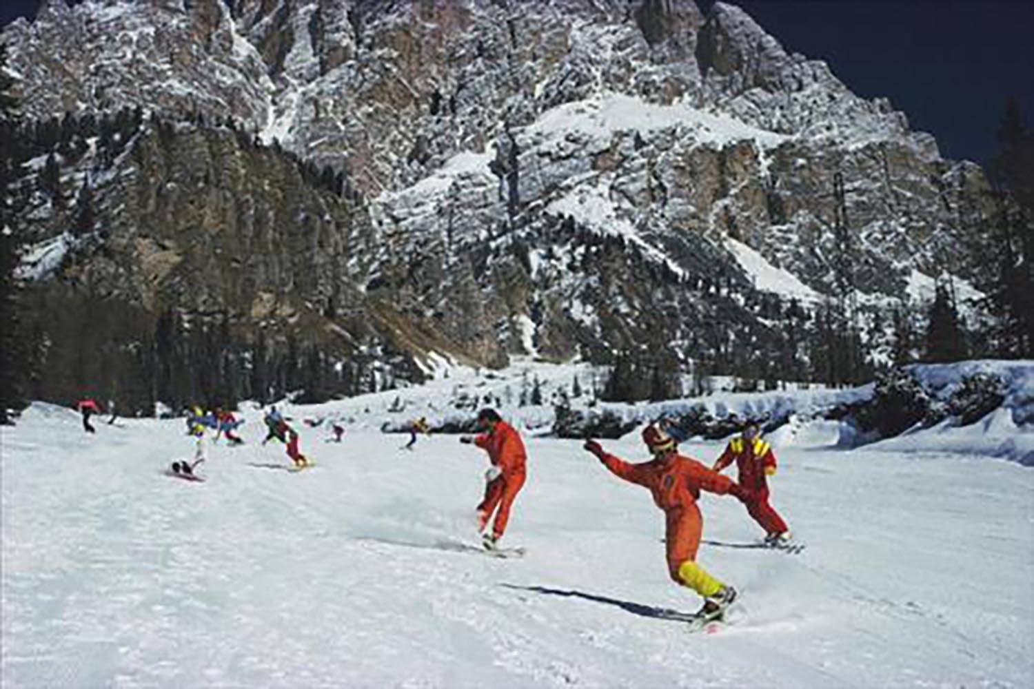 Two women, wearing brightly-coloured skiwear, stand in the foreground of a group of people attending a party in Snowmass Village, in Pitkin County, Colorado, in April 1968. 

40 x 60 inches
$3950

30 x 40 inches
$3350

20 x 30