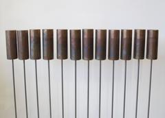 "Aste in acciaio con suonerie a cilindro in ottone".