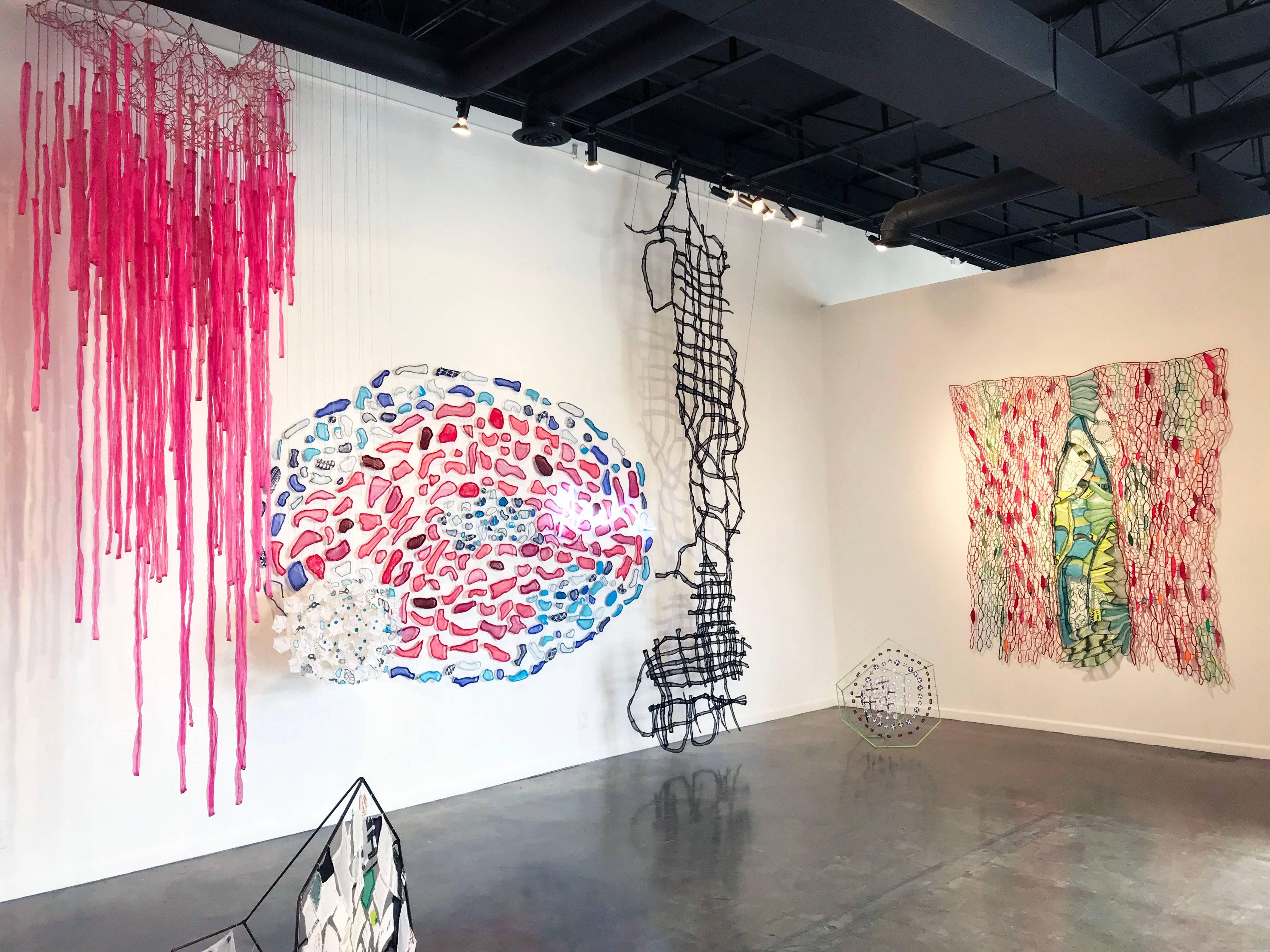 Wider Than The Sky, 2014-2016; 192 x 120 x 76”, fabric, plastic, thread, wire, pipe cleaners, fishing weights, neon; $12,000.

Caroline Lathan-Stiefel’s delicately-webbed “drawings-in-space” cover, divide, encircle, and fill
spaces. Often large in