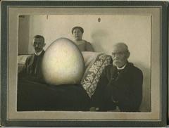 Untitled, Portrait of Three People Around Couch with Giant Egg