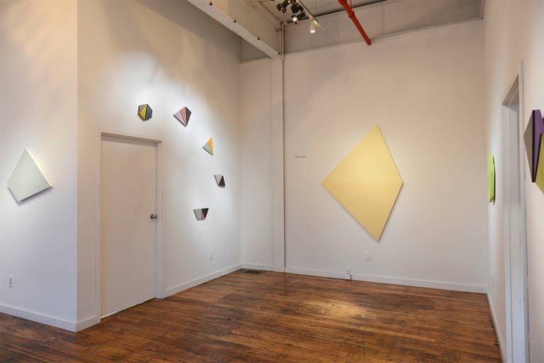 Blinn Jacobs describes her work in a recent statement as being a dialogue between polygonal “shaped” canvases and the use of “painterliness” in regard to the interaction of color. Some of the works retain surface clarity; others become saturated by