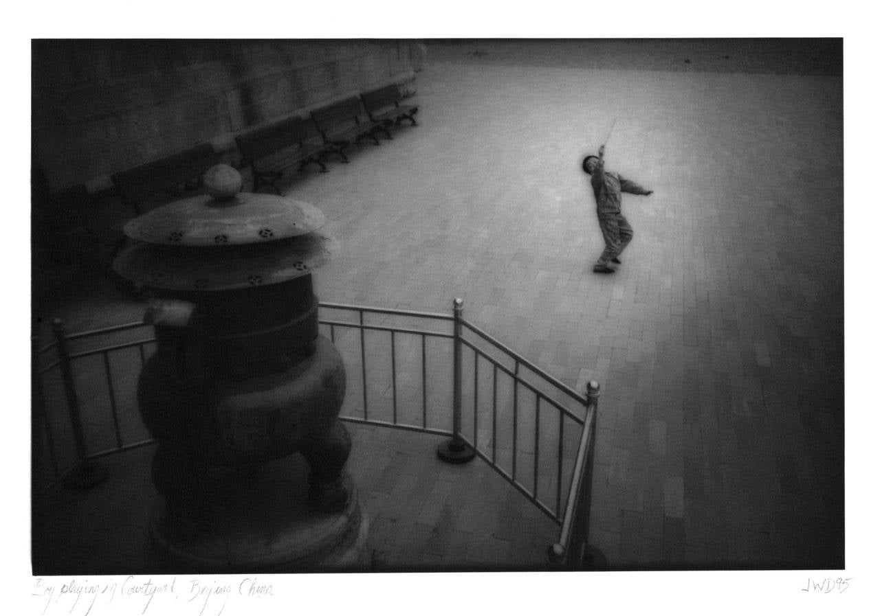 James Whitlow Delano Landscape Photograph - China, Landscape, Boy playing in courtyard, Beijing 