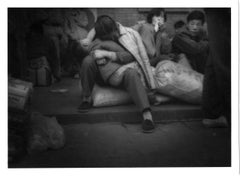 Migrant woman cradles her child in the Beijing Train Terminal, Landscape, China