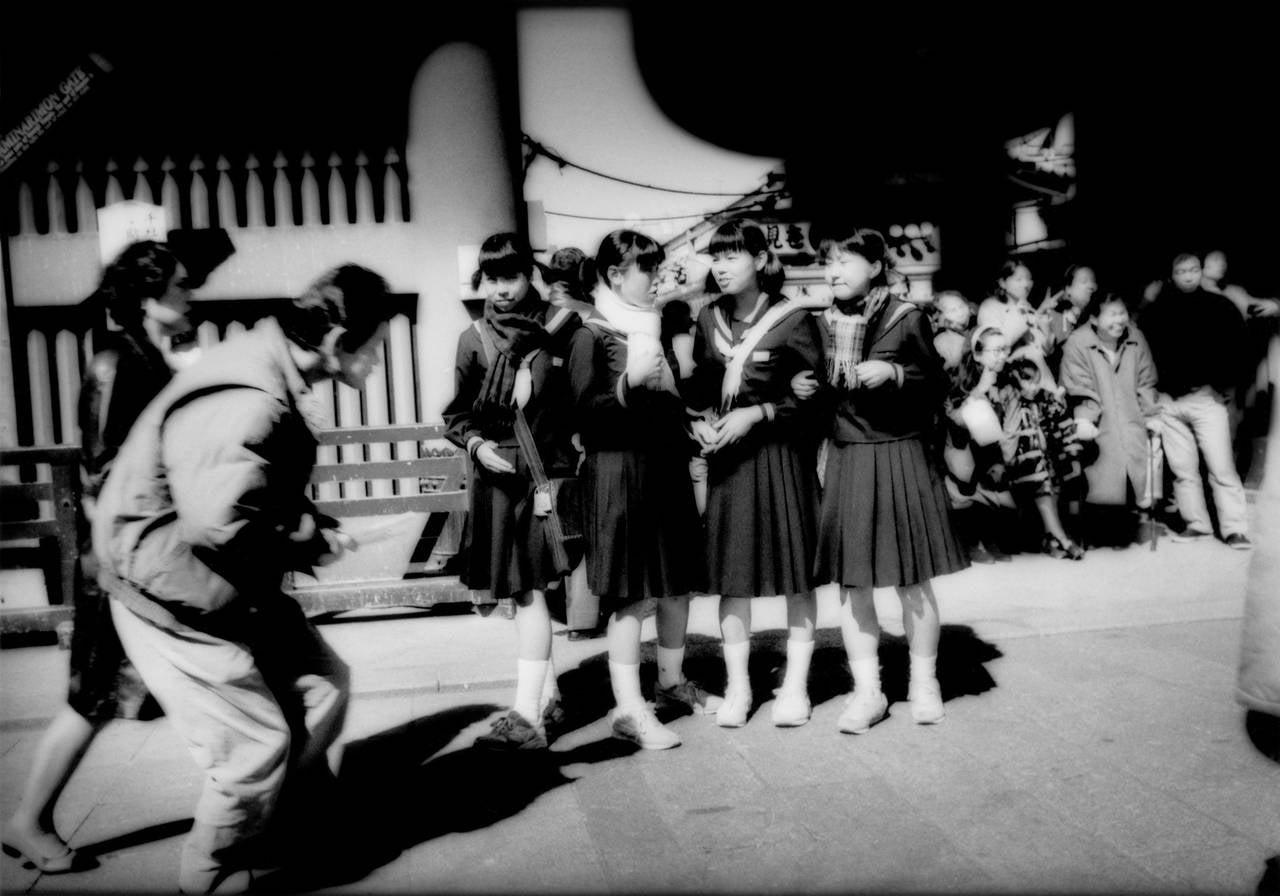 James Whitlow Delano Figurative Photograph - In the path of lenses and avoiding them in front of Kaminari Gate, Tokyo, Japan