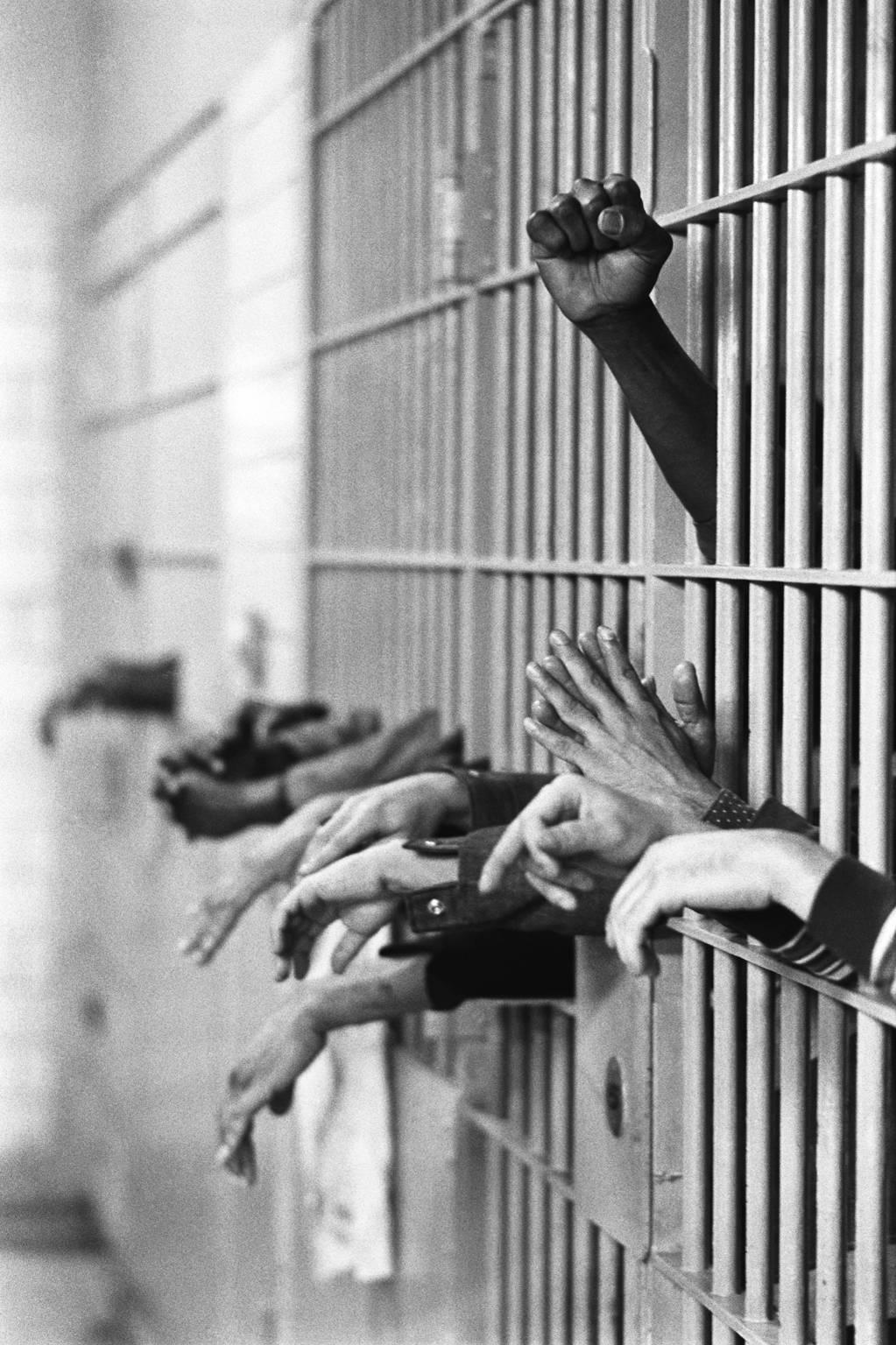 Jean-Pierre Laffont Black and White Photograph - 3 moods in US prisons: Rebellion, prayer, and abandon. Tombs Prison, Manhattan, 