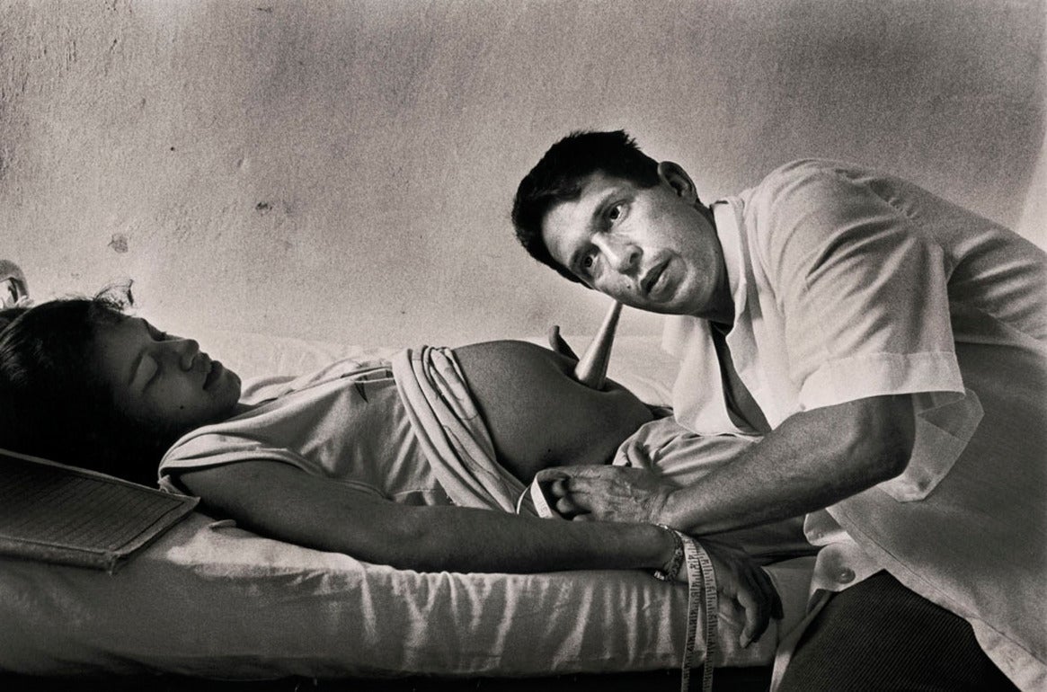 Ernesto Bazan Black and White Photograph - Gynecologist listening to fetal heartbeat, Remedios