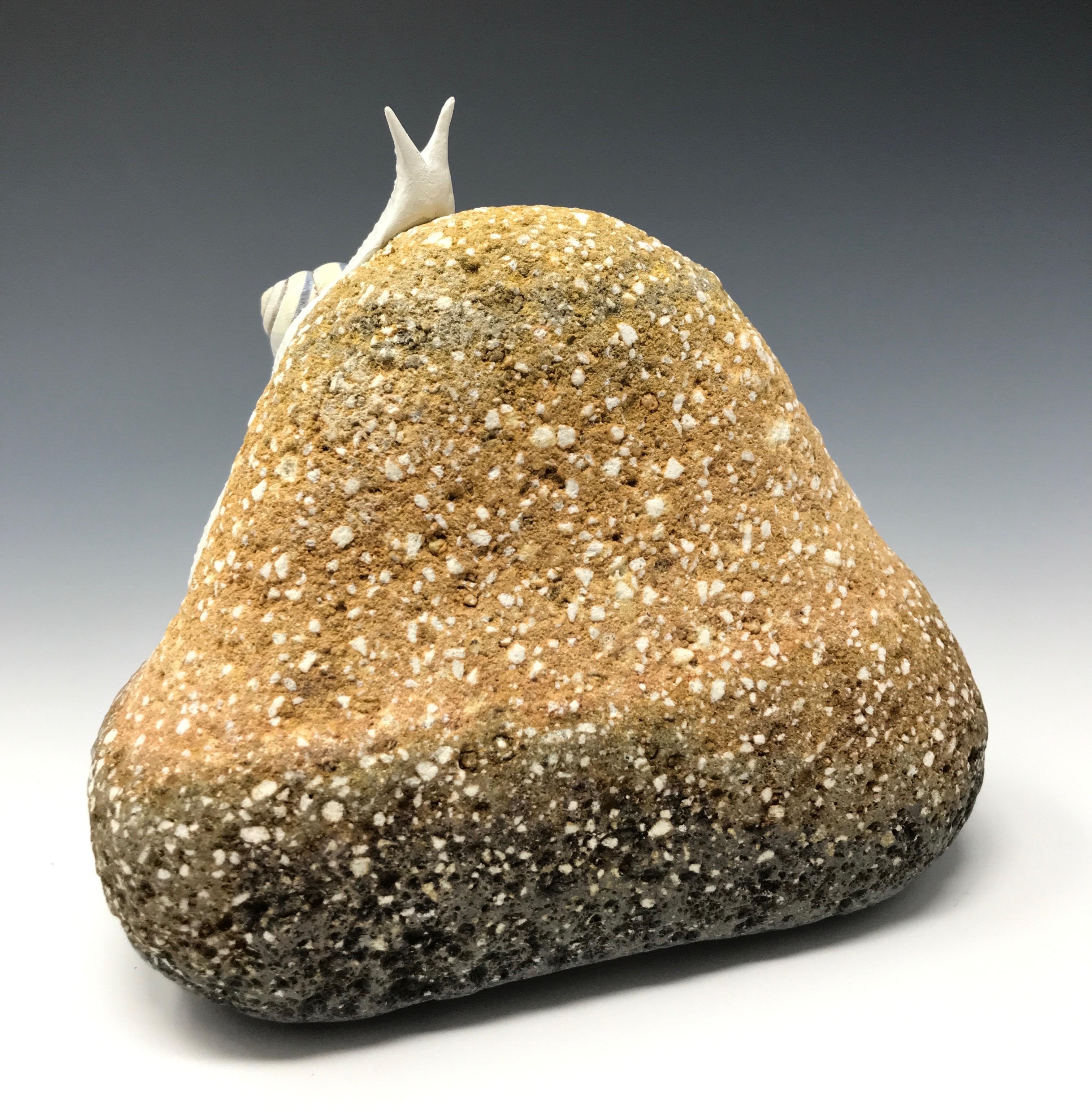 This piece was created with a real found snail shell and durable epoxy clay by New York artist, Bethany Krull. The artist sculpted the undulating snail directly onto a weathered brick found shore-side. The glistening wet snail form is surfaced with