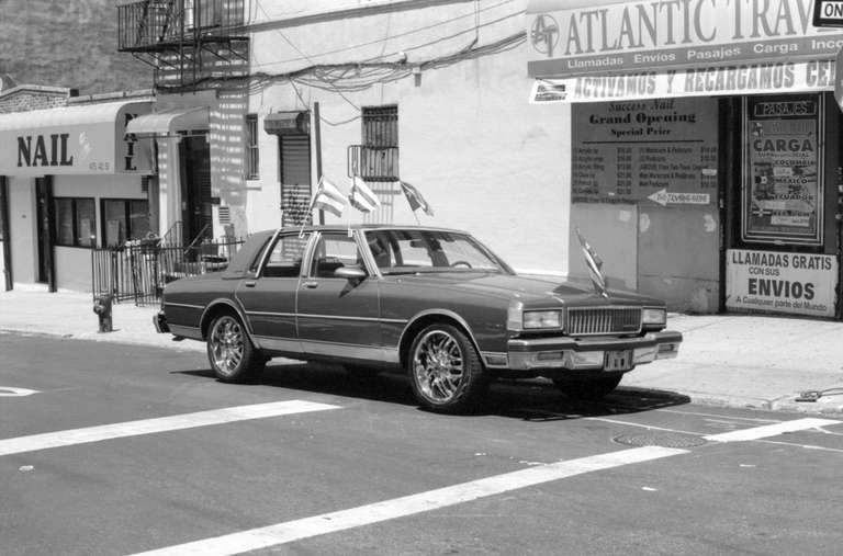 Unknown Black and White Photograph - Cars with Flags