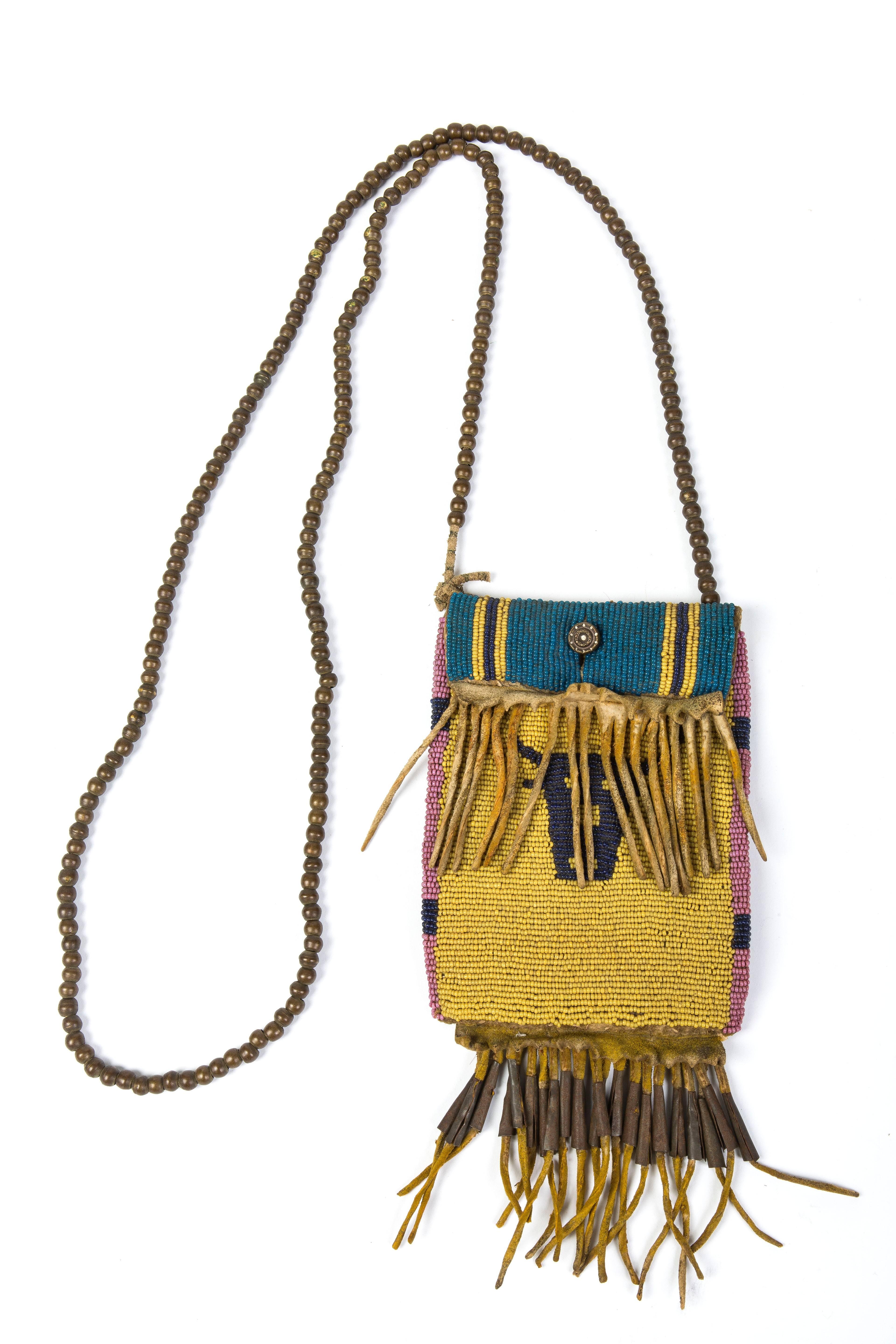American Indian Art
Small beaded bag bison head pattern
Northern Plains, Canada or the USA, circa 1870
Skin, Murano beads, large beads copper, metal cones, leather thongs, sinew, metal button