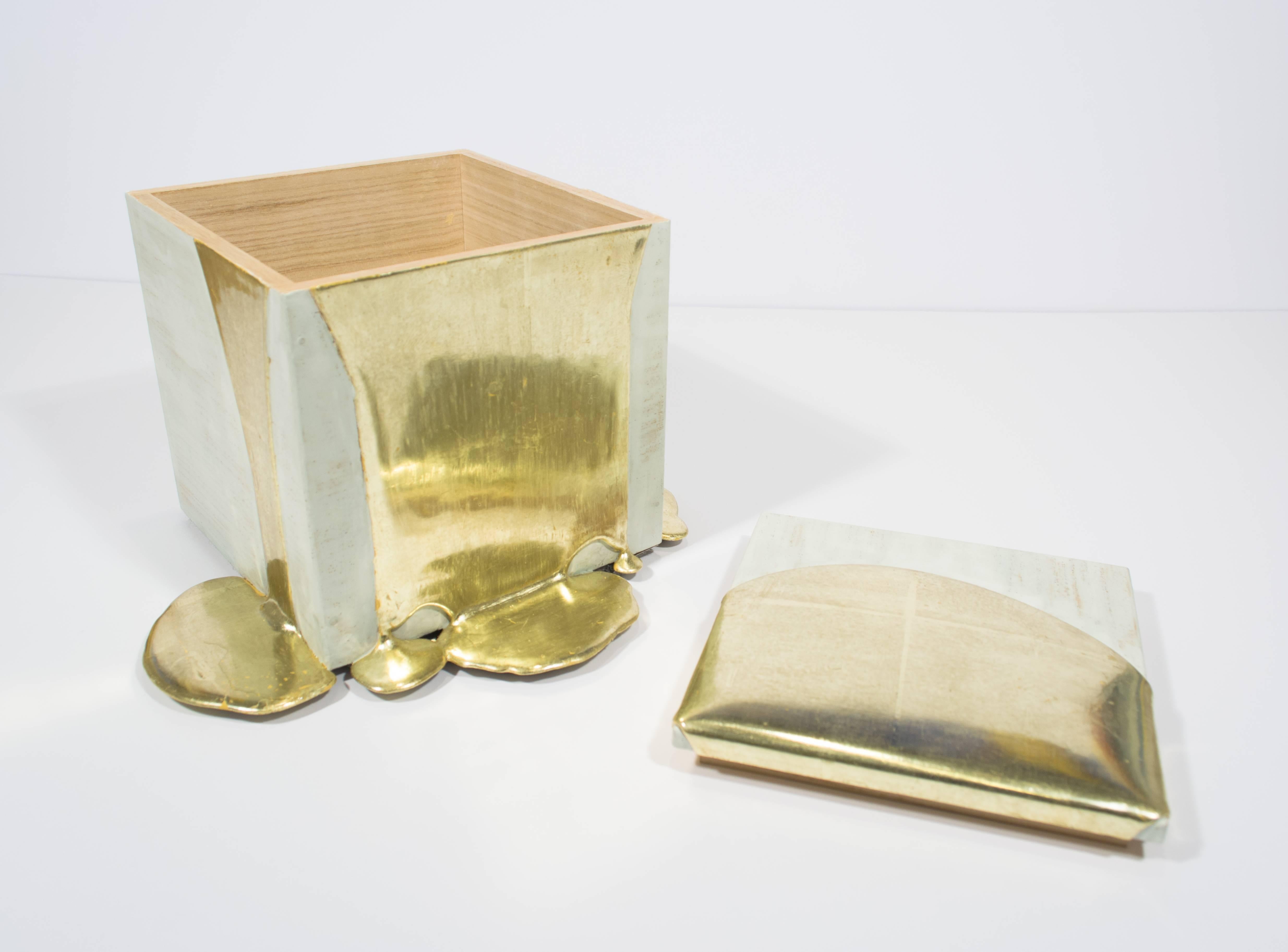 This delicate yet functional box by Nancy Lorenz features a pawlonia box traditionally used for Japanese tea service. To create the effect of poured molten gold, Lorenz builds up layers of gesso, stroke by stroke, and then covers that with white