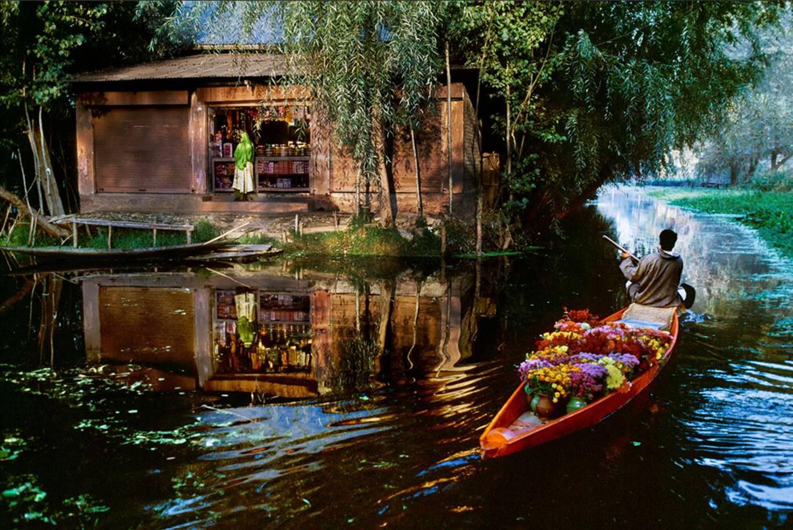 Steve McCurry Color Photograph - Flower Vendor on Dal Lake