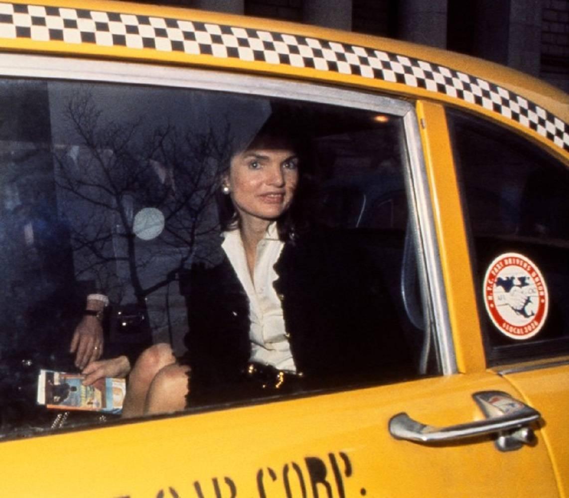 Harry Benson Color Photograph - Jackie in Yellow Taxi, NYC