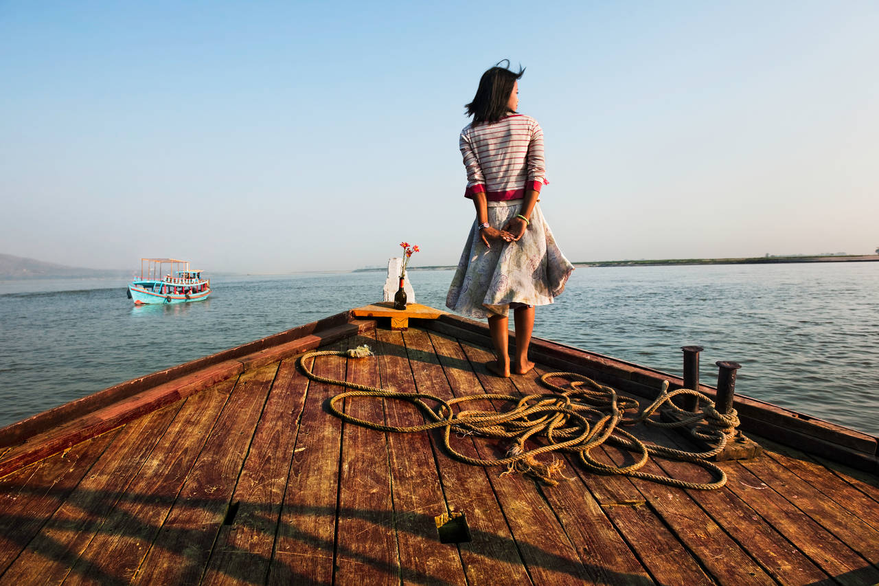 Girl on Ship Prow - Photograph by Steve McCurry