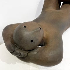 "Recliner Looking Up" bronze sculpture by Joy Brown