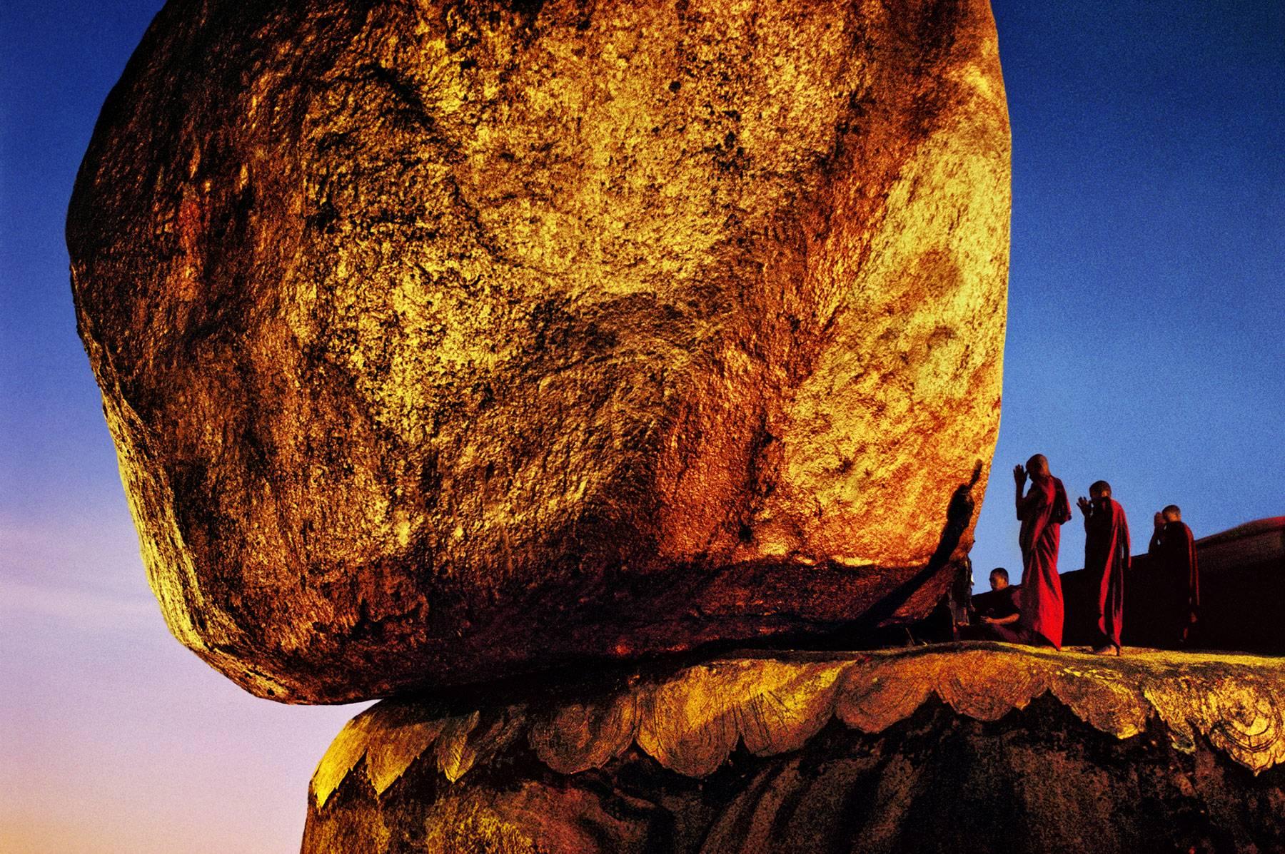 Steve McCurry Color Photograph - Monks Praying at Golden Rock, Kyaikto