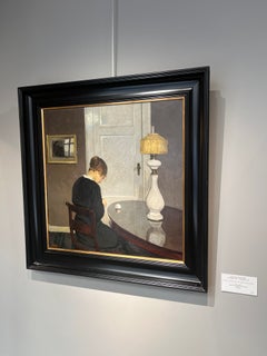 Woman sewing seen from behind in a Danish Interior